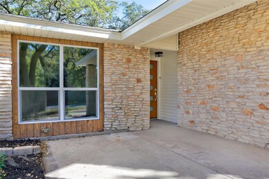 Property entrance featuring stone siding and a pa