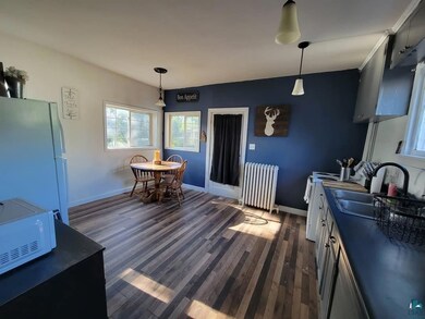 Kitchen featuring radiator heating unit, white app