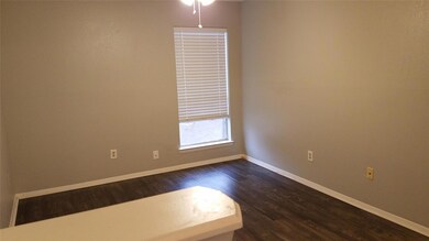 Unfurnished room with dark wood-type flooring, ba