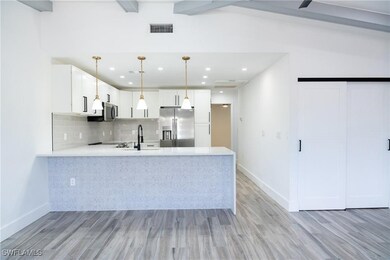 Kitchen with decorative backsplash, light countert