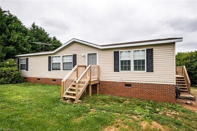 Front view of the home composed of brick and vinyl siding.
