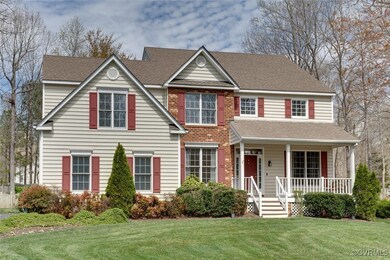 View of front facade featuring covered porch, roof