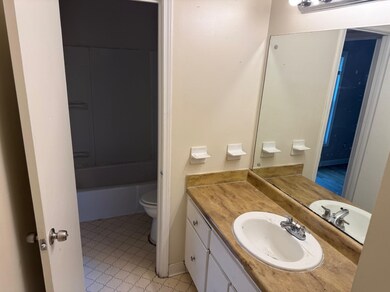 Bathroom with vanity and  shower combination