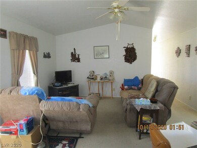 15x15 Living Room with lighted ceiling fan , carpet Flooring.