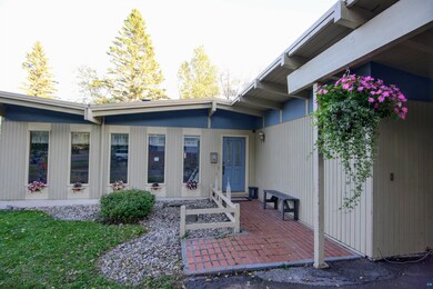 Doorway to property featuring a patio and attached