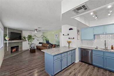 Kitchen with blue cabinetry, stainless steel dishw