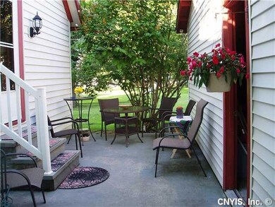 Patio/Deck. Charming patio area between the garage