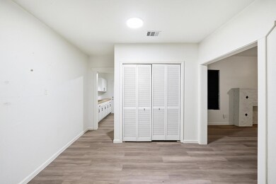 Unfurnished bedroom featuring light wood-style flooring and a closet