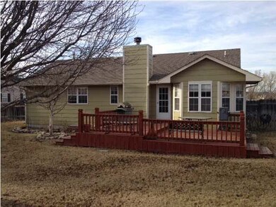 Back view of home with large deck.