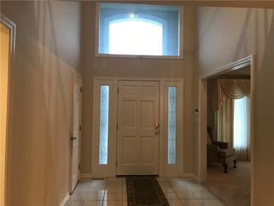 Spacious tiled entry - lots of natural lighting!  Covered porch.