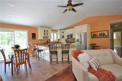 Open floor plan situates kitchen,...