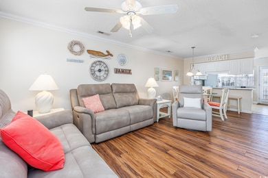 Living area with visible vents, ornamental molding