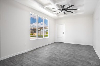 Unfurnished room featuring coffered ceiling, beamed ceiling, dark wood finished floors, a ceiling fan, and recessed lighting