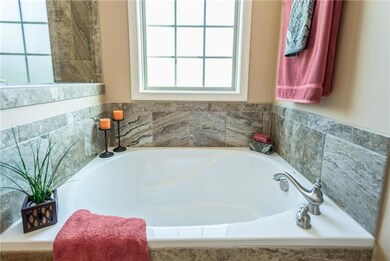 Soaking tub with tile surround.