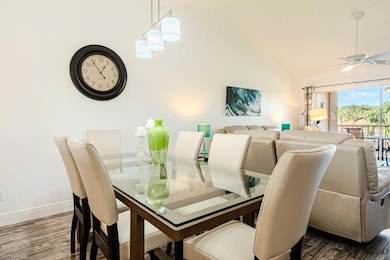 Kitchen featuring white cabinetry, a chandelier, light wood-type flooring, sink, and white appliances