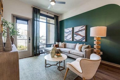 Living room with wood-type flooring and ceiling fa