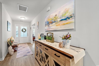 Foyer entrance featuring light wood-style floors and baseboards