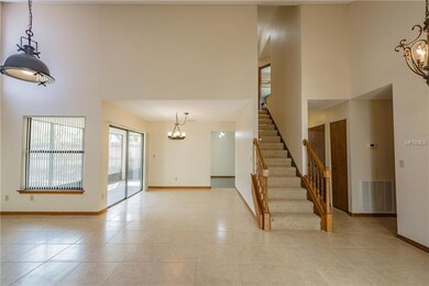 Living room and dining room with beautiful stairca