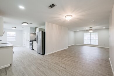 Another look at the dining room with a peak at the kitchen and a view of the living room.