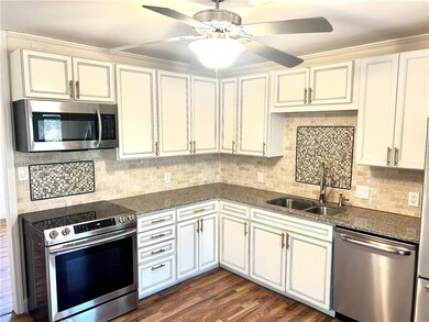 Kitchen with sink, backsplash, stainless steel app