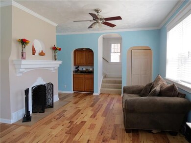 THE LIVING ROOM FEATURES A NEWER WOOD FLOOR, WOOD 