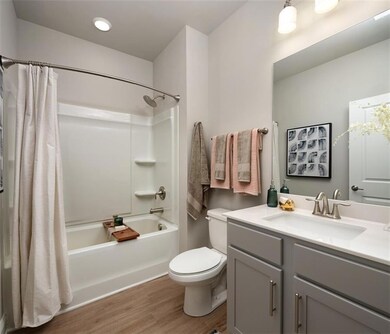 Full bathroom with vanity with extensive cabinet s