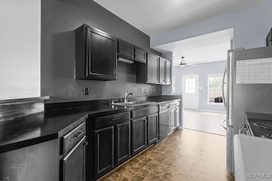 Kitchen featuring dishwasher, dark floors, ceiling