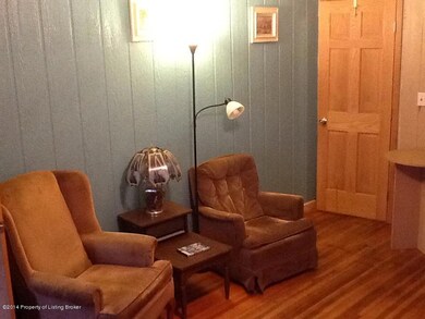 Attractive den with hardwood floors