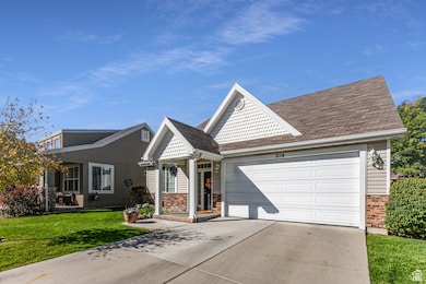 View of front facade featuring driveway, a front lawn, a garage, and a shingled roof