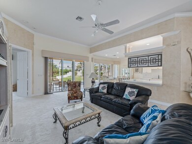 Living room featuring crown molding, ceiling fan,