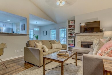 Wood-burning fireplace and huge windows make this 