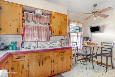 Kitchen with sink, decorative backsplash, ceiling 