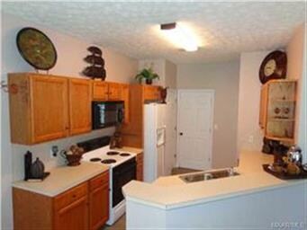 The kitchen has a breakfast bar to accommodate add