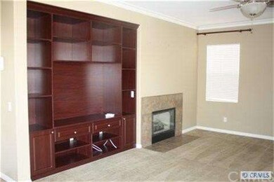 Den w/ bulitin cabinet and fireplace