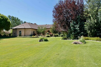View of front of home featuring a front lawn, stucco siding, and a tile roof