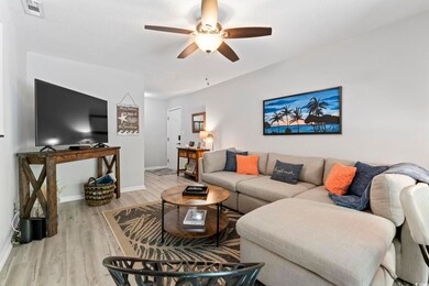 Living area with ceiling fan, wood finished floors