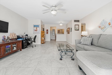 Living area featuring an office area, light tile patterned floors, and ceiling fan