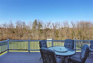 Oversized rear deck off kitchen affords privacy an