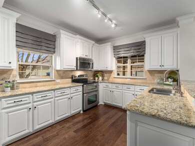 The kitchen showcases granite countertops, painted