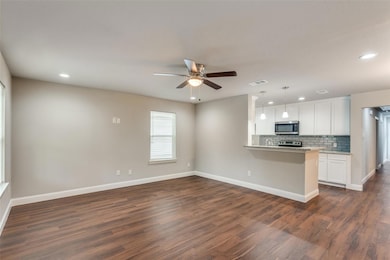 Kitchen featuring stainless steel microwave, backs