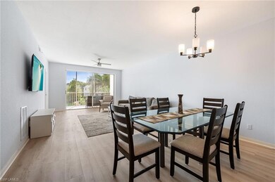 Dining room with light wood-style floors, a ceiling fan, and a chandelier