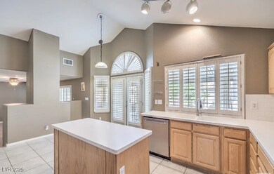 Kitchen with dishwasher, light countertops, light