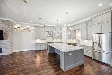 A spacious kitchen with a massive granite island,