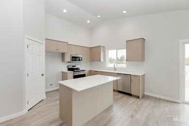 Kitchen with stainless steel appliances, high vaulted ceiling, a center island, light wood-style flooring, and recessed lighting