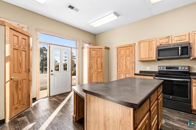 Kitchen featuring a kitchen island, visible vents,