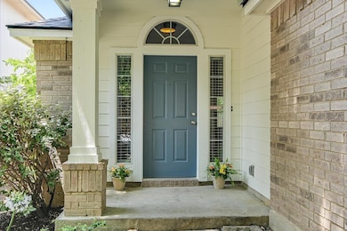 Entrance to property featuring brick siding and c