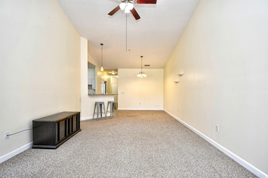 Unfurnished living room featuring ceiling fan with