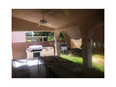 Exterior Back. Covered patio with ceiling fans, bu