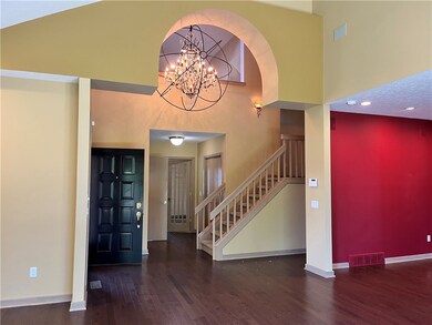 A view of the foyer entrance and oversized chandel