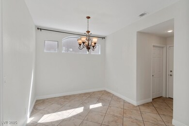 Unfurnished room featuring a chandelier and light tile patterned floors